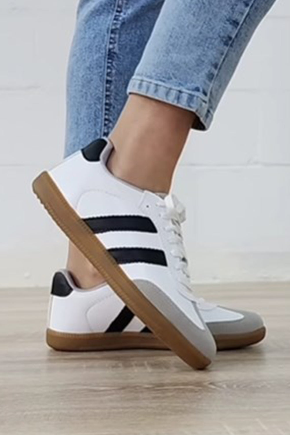 Women's white lace-up sneakers with flat sole for comfortable everyday wear