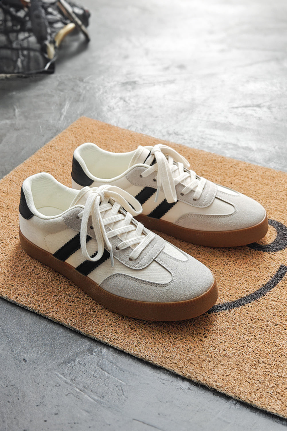 Women's white lace-up sneakers with flat sole for comfortable everyday wear on the ground