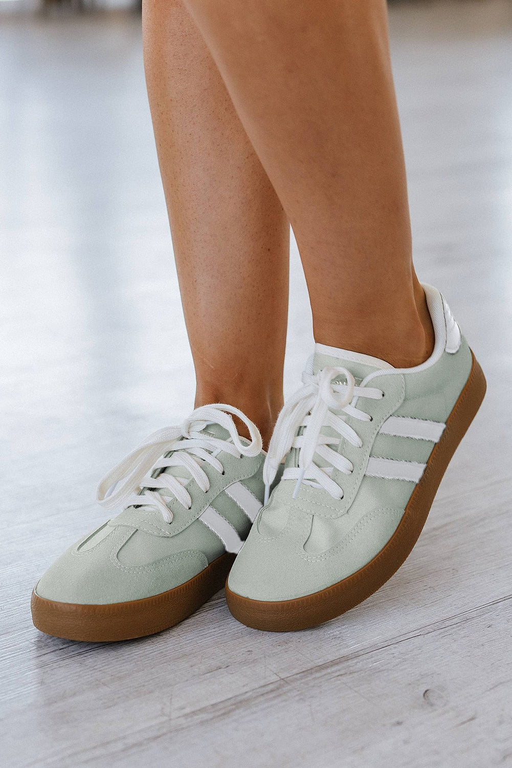 Women's white lace-up sneakers with flat sole for comfortable everyday wear