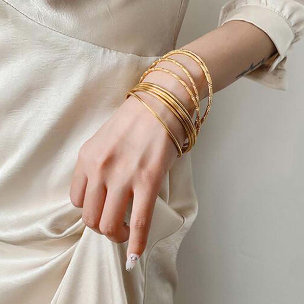 Elegant gold alloy bracelet set for women - 7-pack with unique patterns, perfect for daily wear and special occasions.