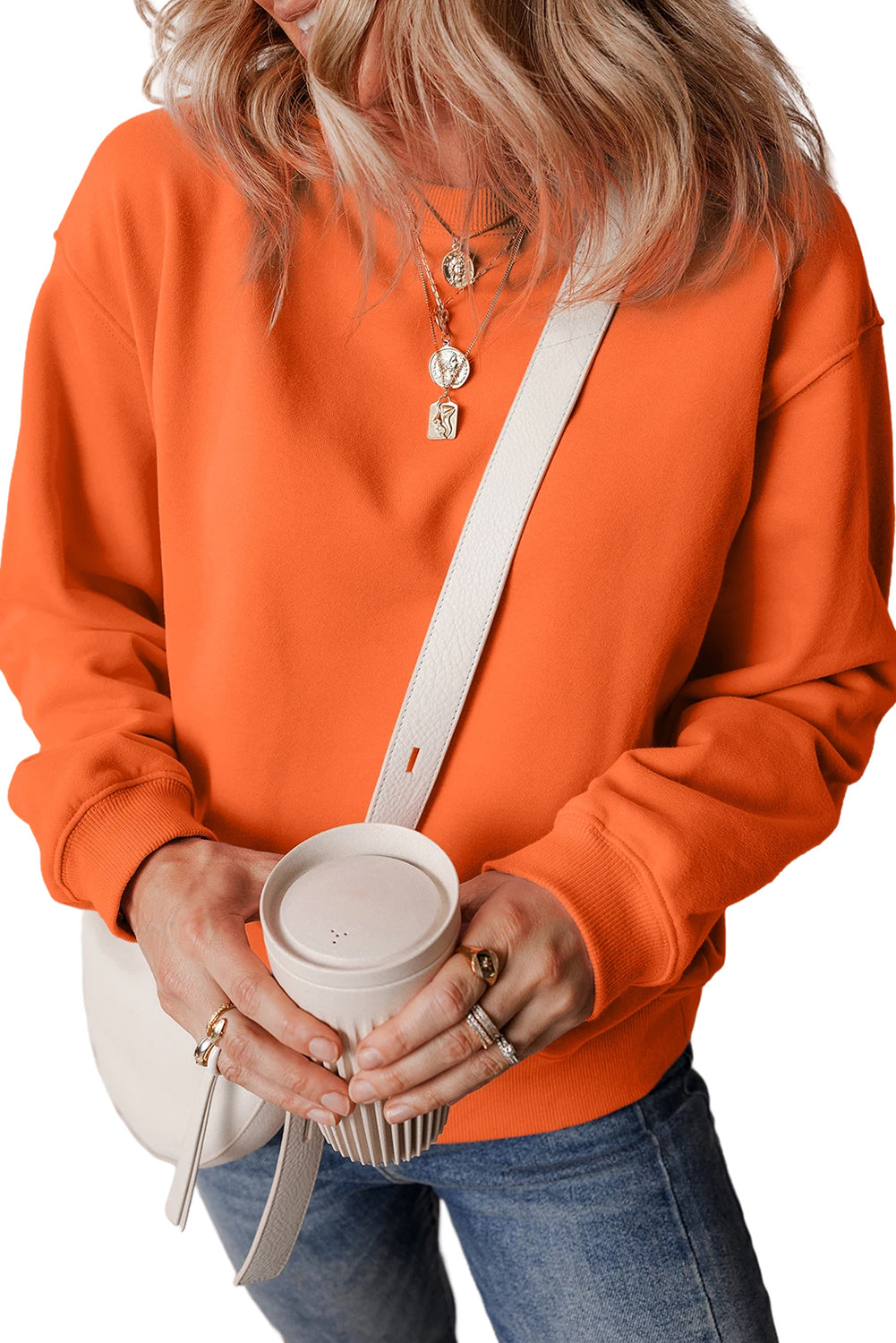 orange drop shoulder sweatshirt on a hanger showcasing soft terry fabric and relaxed fit