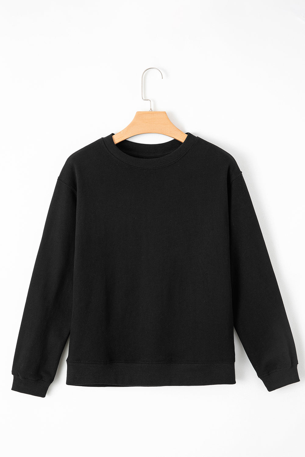 Black drop shoulder sweatshirt on a hanger showcasing soft terry fabric and relaxed fit