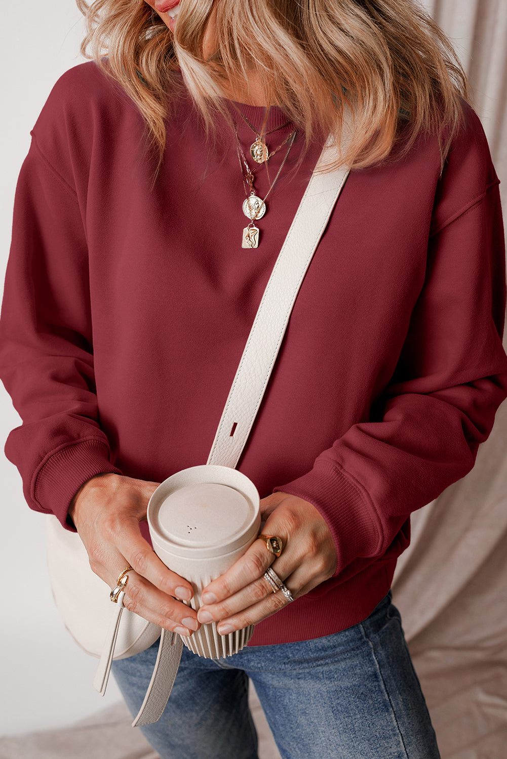 Burgundy drop shoulder sweatshirt on a hanger showcasing soft terry fabric and relaxed fit