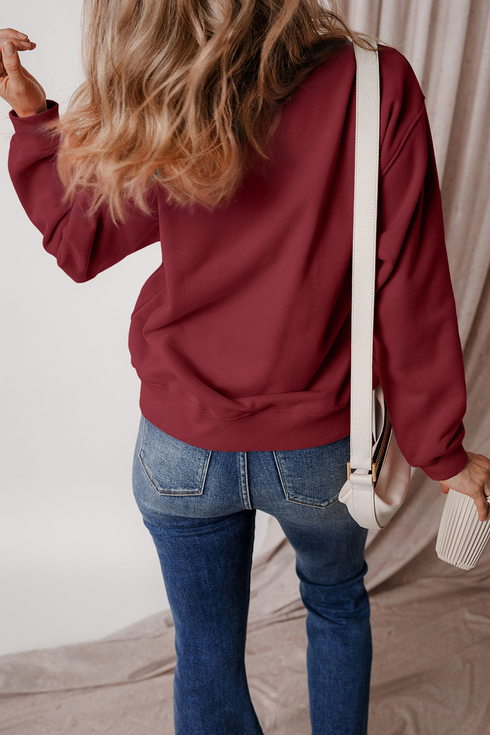 Burgundy drop shoulder sweatshirt on a hanger showcasing soft terry fabric and relaxed fit - Back View
