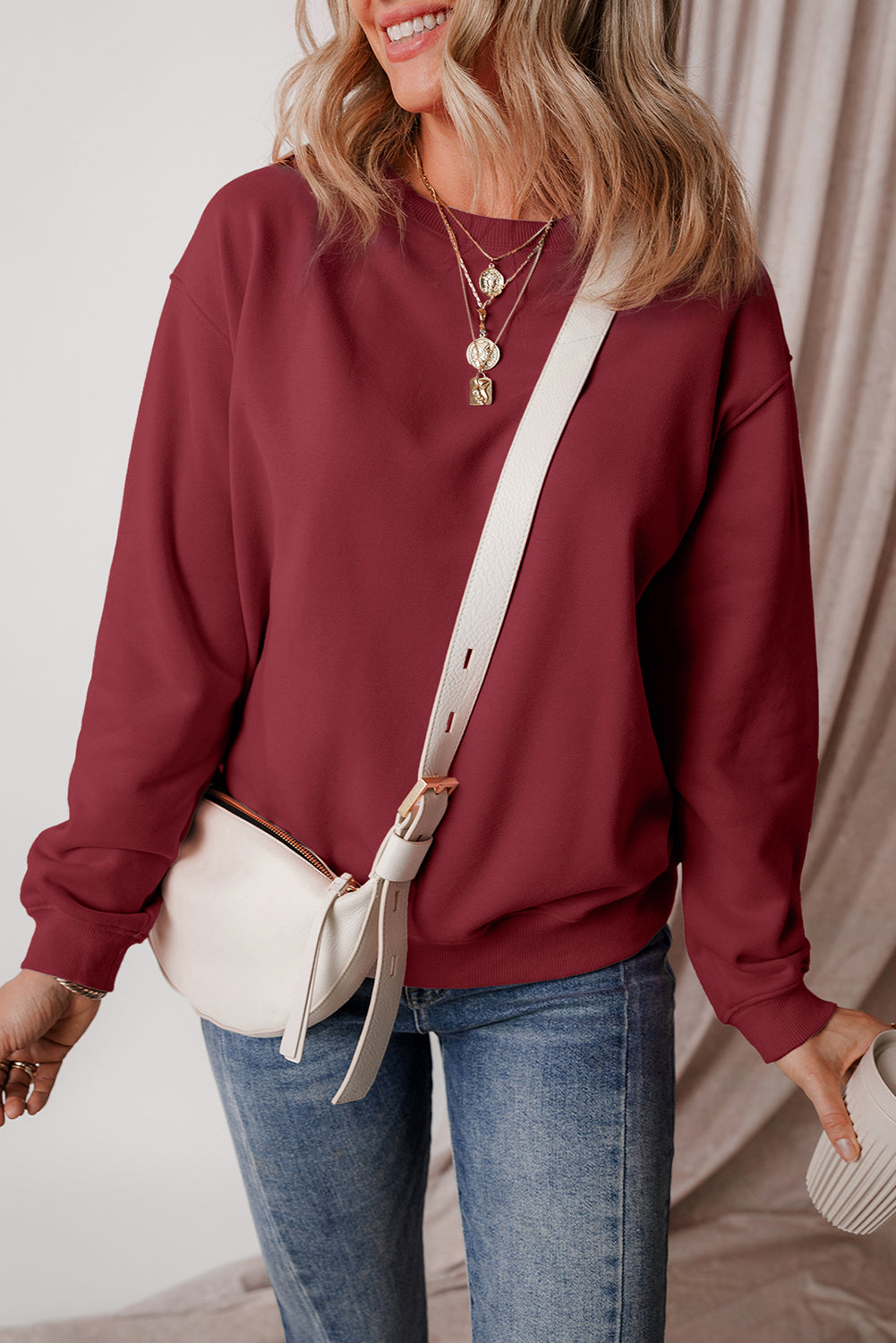 Burgundy drop shoulder sweatshirt on a hanger showcasing soft terry fabric and relaxed fit - Front View