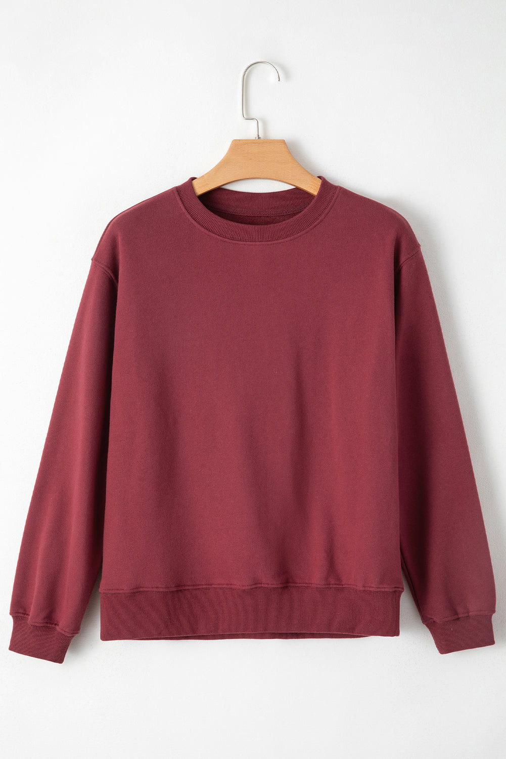 Burgundy drop shoulder sweatshirt on a hanger showcasing soft terry fabric and relaxed fit - Front View-v2