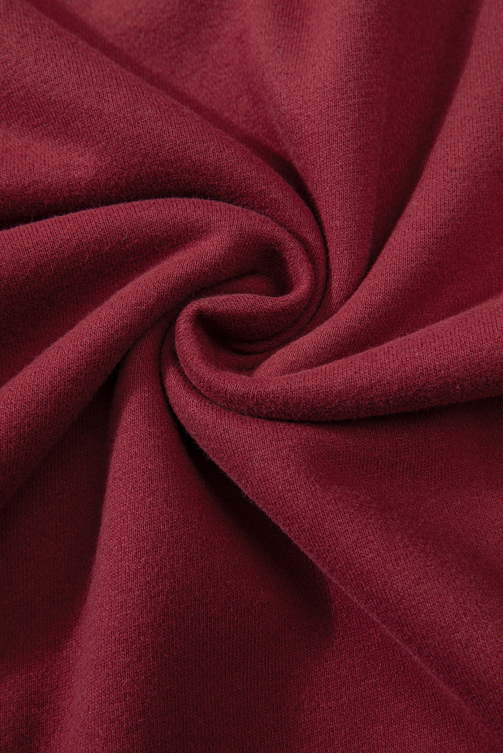 Close-up of dark green sweatshirt fabric and drop shoulder design