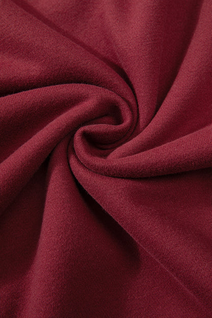 Close-up of dark green sweatshirt fabric and drop shoulder design