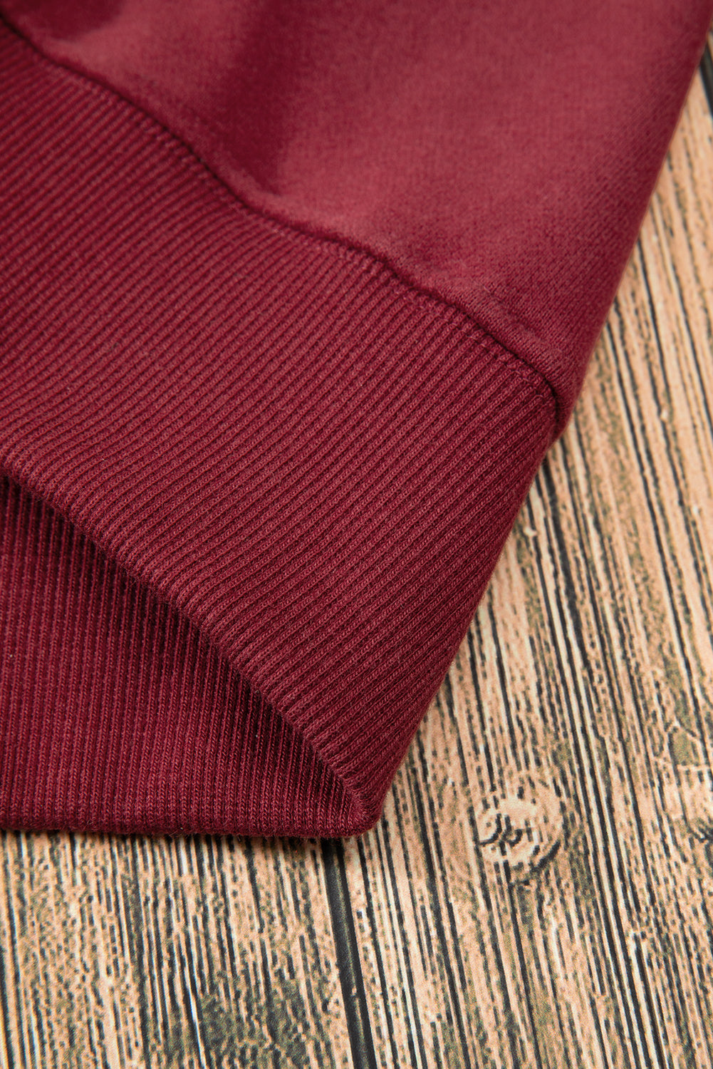 Close-up of dark green sweatshirt fabric and drop shoulder design