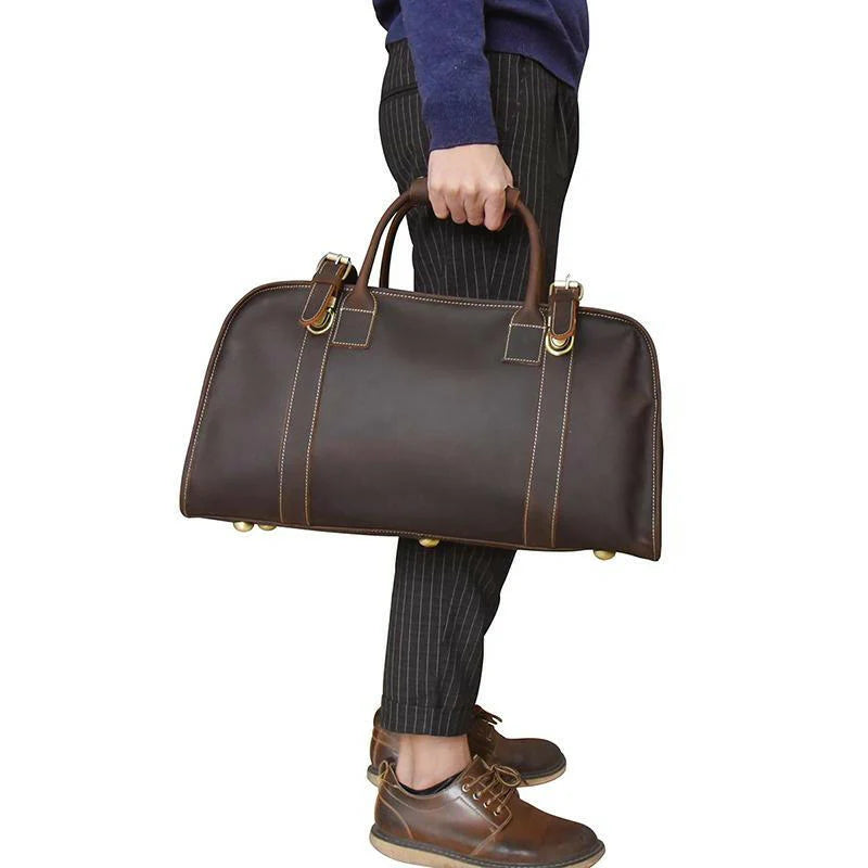 Erlend Duffle Bag made of genuine horse leather with leather handles and adjustable shoulder strap.