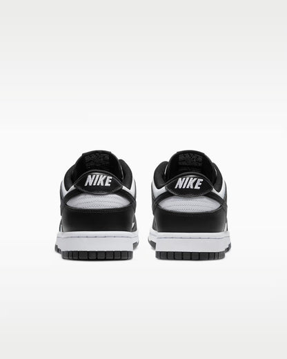 Black and white Nike sneakers shown from the back on a light gray background