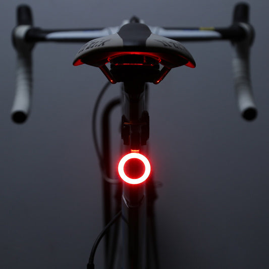 Rechargeable bicycle taillight with COB LED and USB charging, compact and lightweight design.