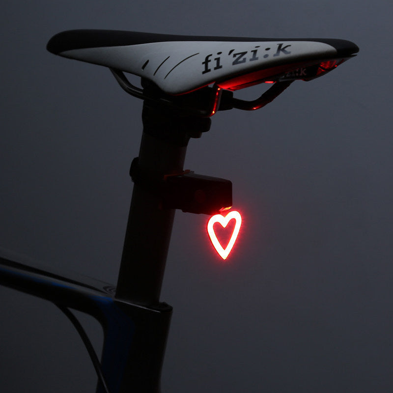 Rechargeable bicycle taillight with COB LED and USB charging, compact and lightweight design.