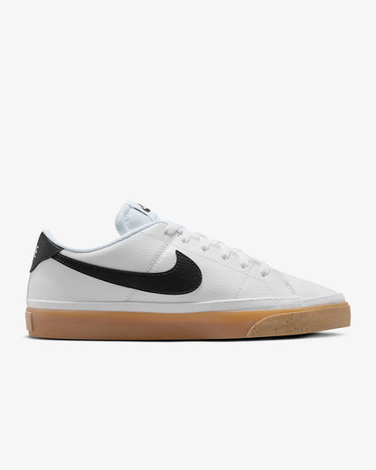 Nike Court Legacy Next Nature sneakers in white with gum yellow outsole and synthetic leather upper. Side view.