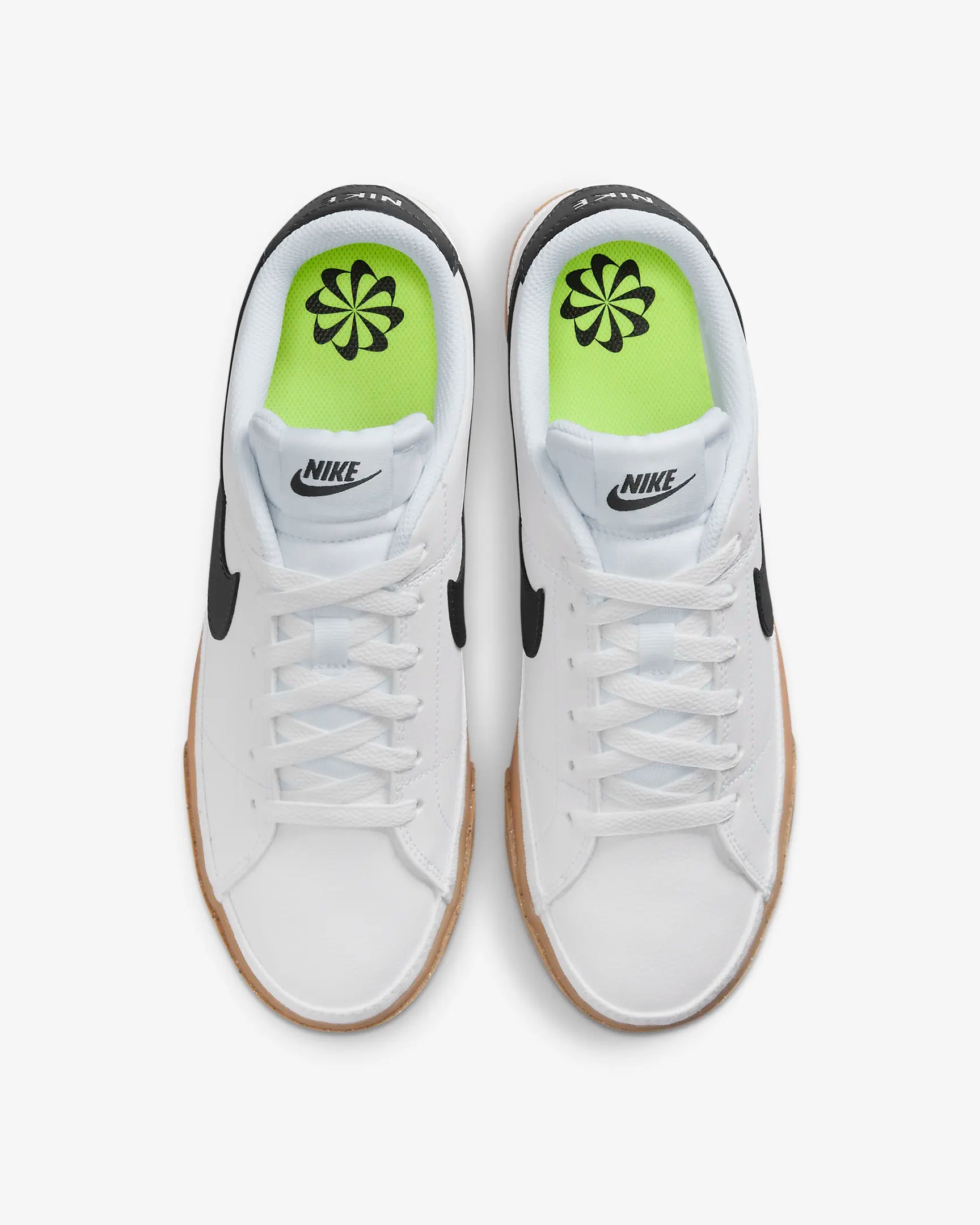 Nike Court Legacy Next Nature sneakers in white with gum yellow outsole and synthetic leather upper. Top view.