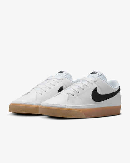 Nike Court Legacy Next Nature sneakers in white with gum yellow outsole and synthetic leather upper.