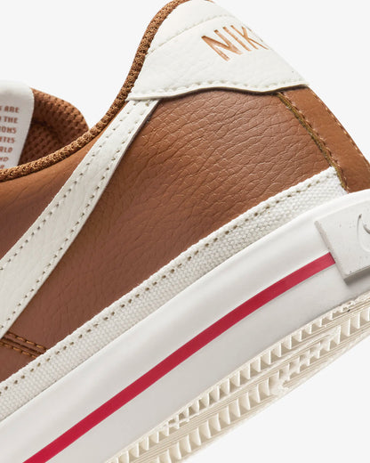 Nike Court Legacy Next Nature sneakers in Light British Tan with Fire Red and Sail accents.