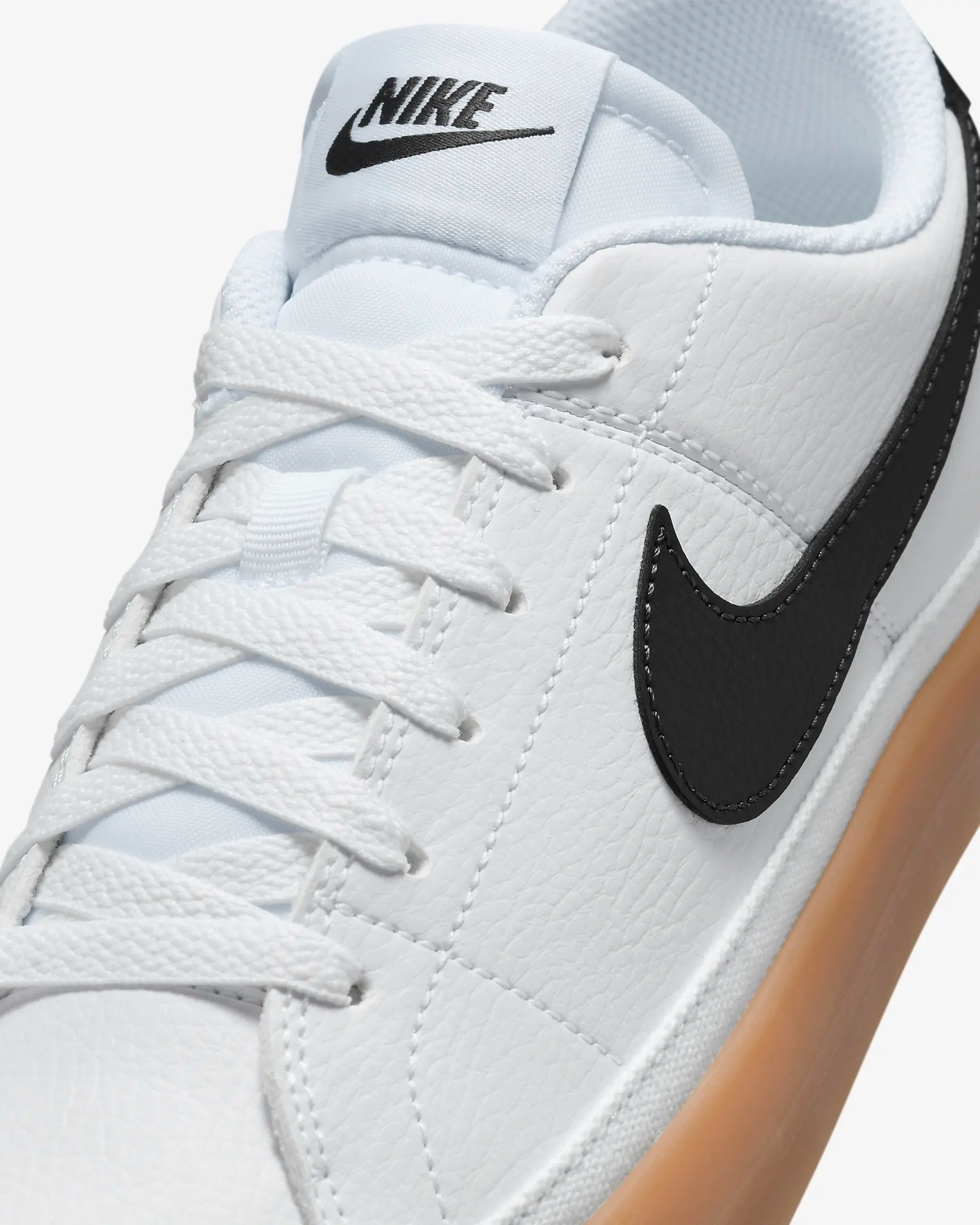 Nike Court Legacy Next Nature sneakers in white with gum yellow outsole and synthetic leather upper.