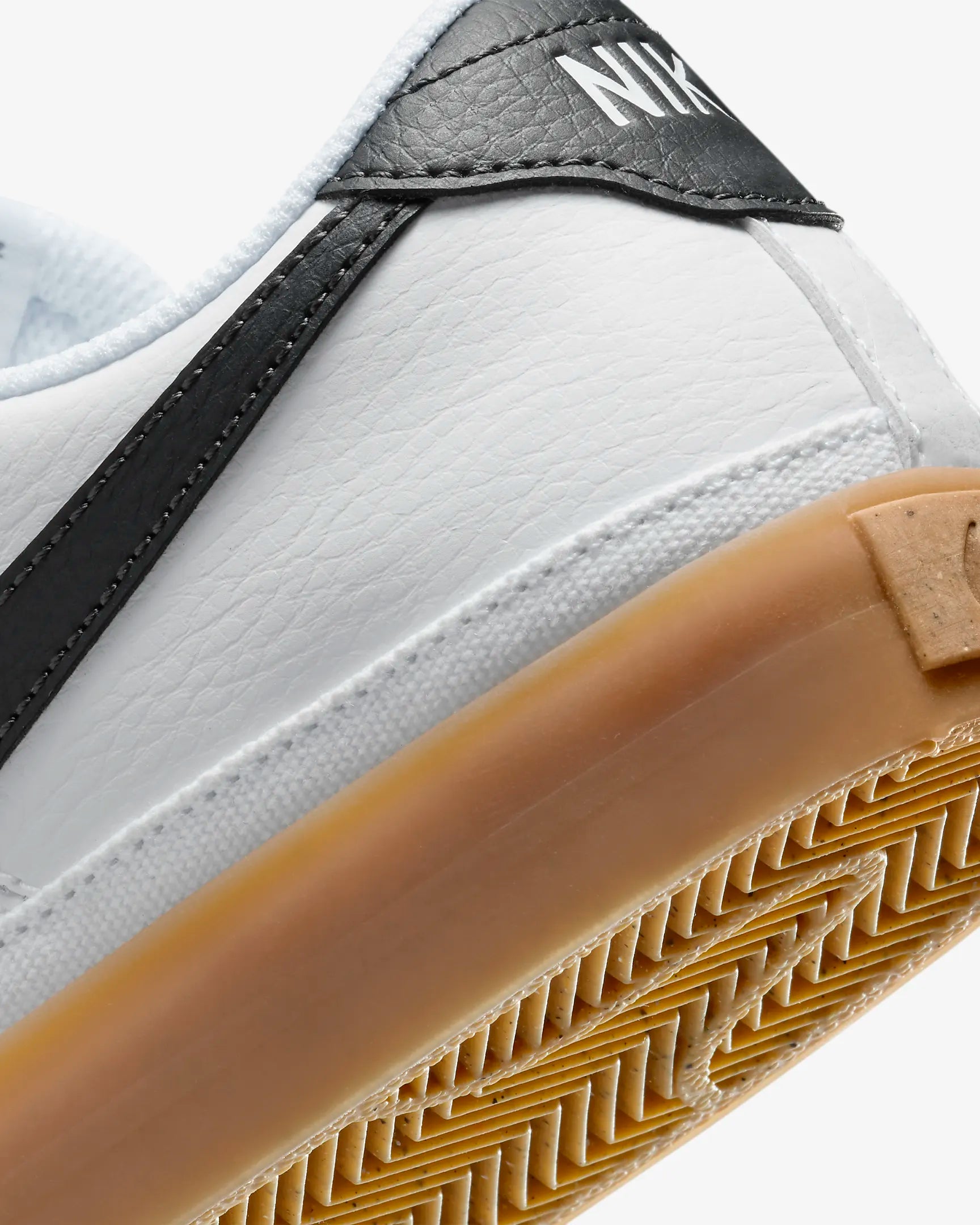 Nike Court Legacy Next Nature sneakers in white with gum yellow outsole and synthetic leather upper. Back view.
