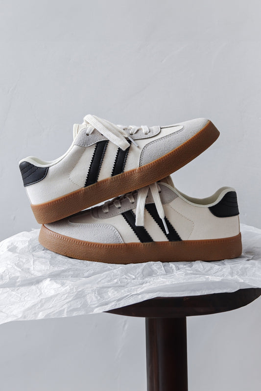 Women's white lace-up sneakers with flat sole for comfortable everyday wear