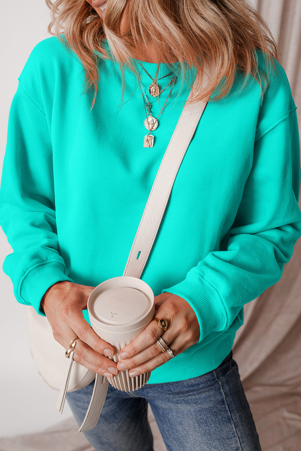 green drop shoulder sweatshirt on a hanger showcasing soft terry fabric and relaxed fit