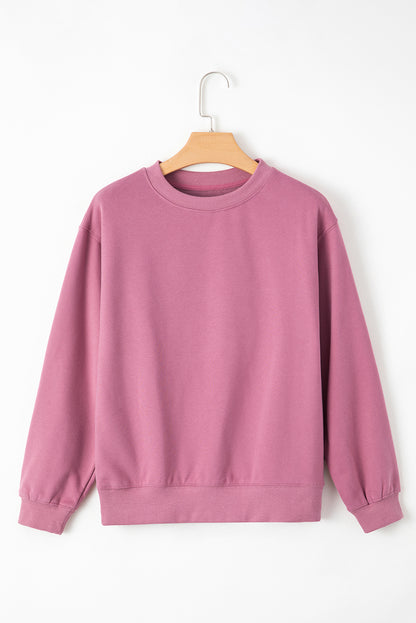 pink drop shoulder sweatshirt on a hanger showcasing soft terry fabric and relaxed fit