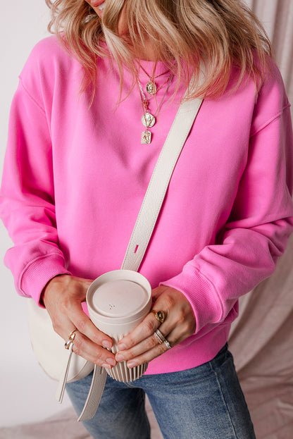 pink drop shoulder sweatshirt on a hanger showcasing soft terry fabric and relaxed fit
