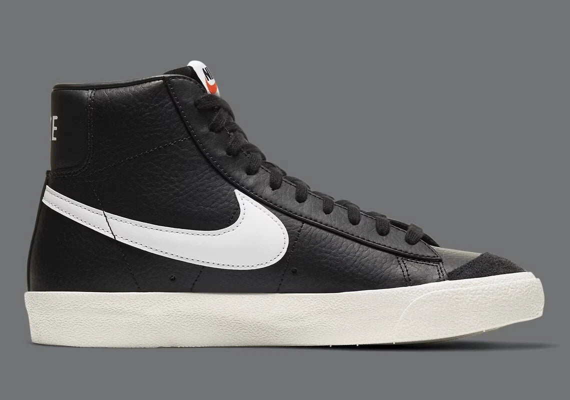 Black high-top sneaker with white swoosh logo on a gray background